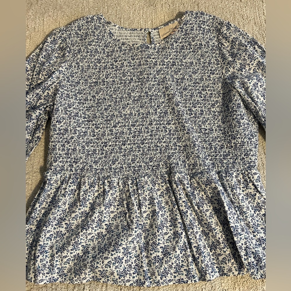 Blue and white floral smocked peplum blouse.